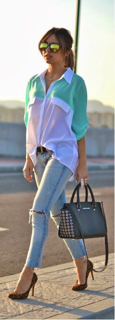 Medium spring green and white oversized shirt with sky blue stylish jeans and black leather hand bag and leopard heels